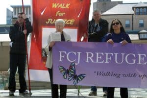 Sr Lois Anne Bordowitz FCJ speaks at the third station with members of the FCJ Refugee Centre