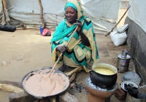 Lelia prepares food for her family in Gendrassa Refugee Camp in Maban, South Sudan. (Photo: A. Wells/JRSEA)