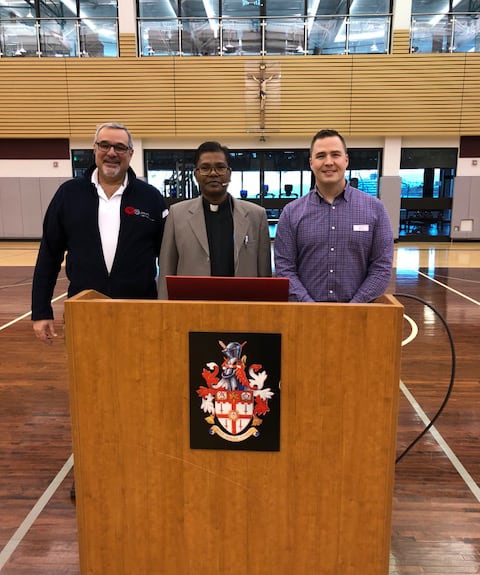 Fr. Lalit Tirkey SJ (centre) at St. Paul's High School, Winnipeg, with Fr Len Altilia SJ, President (at left), and Rob Lewin, Principal. (Photo: CJI)